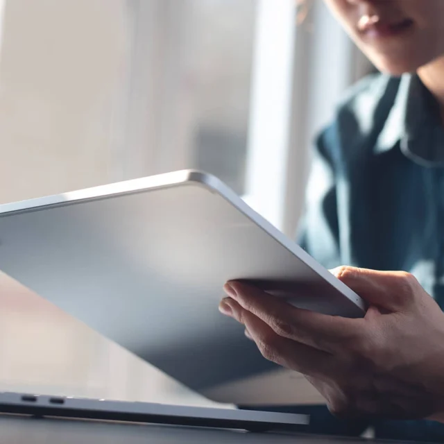Person on tablet and laptop